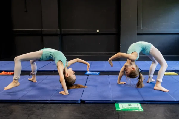 gymnasts-practicing-on-blue-mats