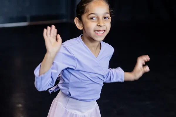 Tiny dancer in a lilac leotard and skirt dancing in the studio